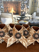 Hand made brown and white peppered cowhide napkin rings with berry conchos - Your Western Decor