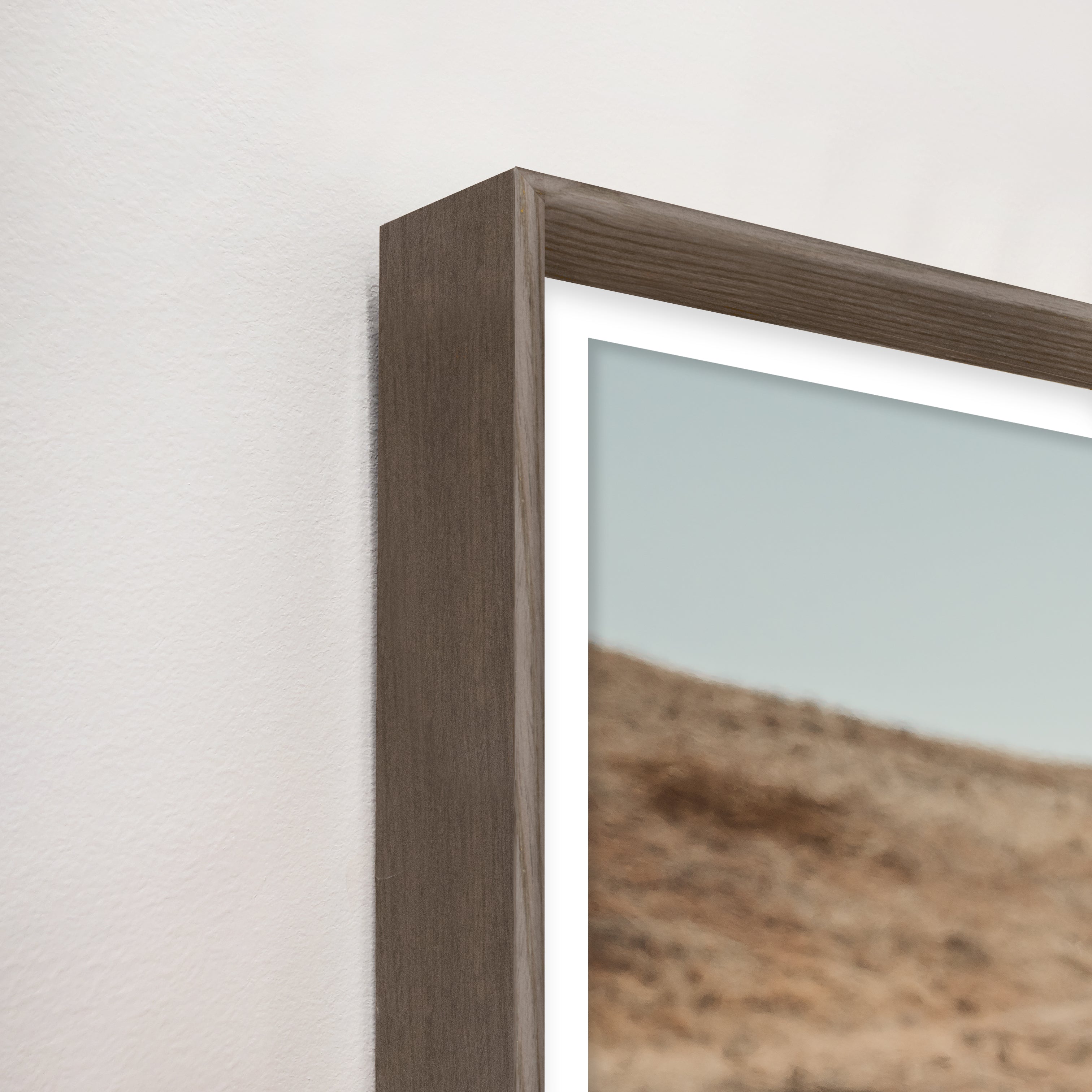 Close-up of a wooden picture frame with a landscape photo inside - Blue Mountain Brands USA