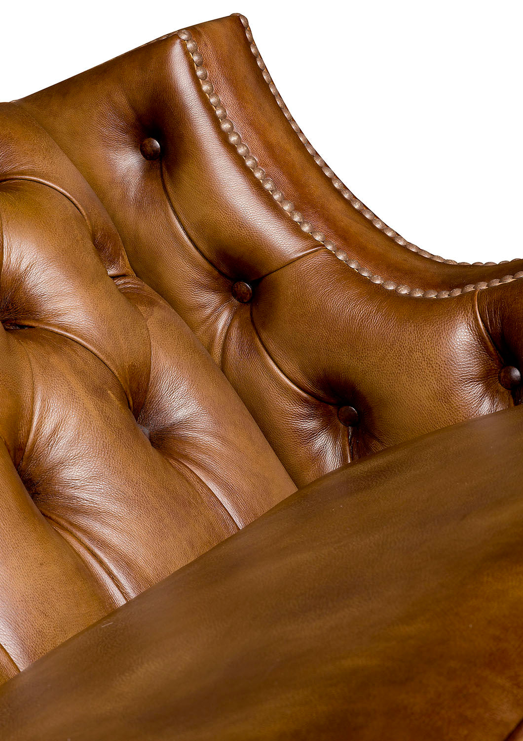 Close-up of a brown leather sofa with tufted backrest and button details