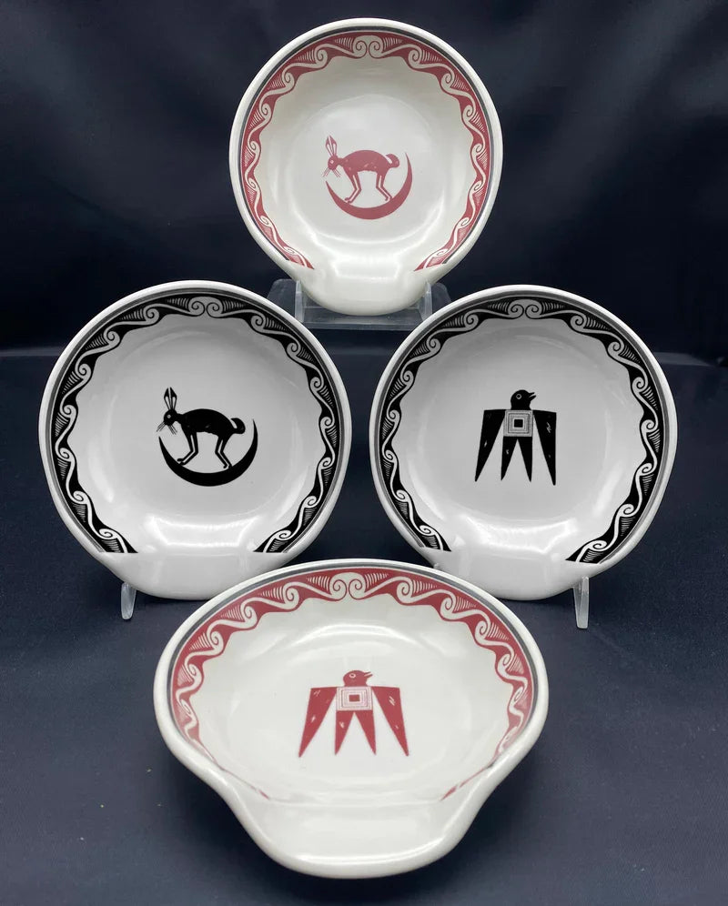 Set of four ceramic spoon rests with decorative symbols on a dark background - Blue Mountain Brands USA