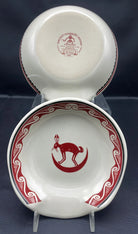 Ceramic spoon rest with red decorative design on a stand against a dark background - Blue Mountain Brands USA
