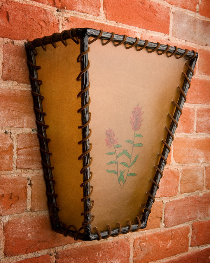 Rawhide and iron laced wall sconce handmade and painted in Wyoming