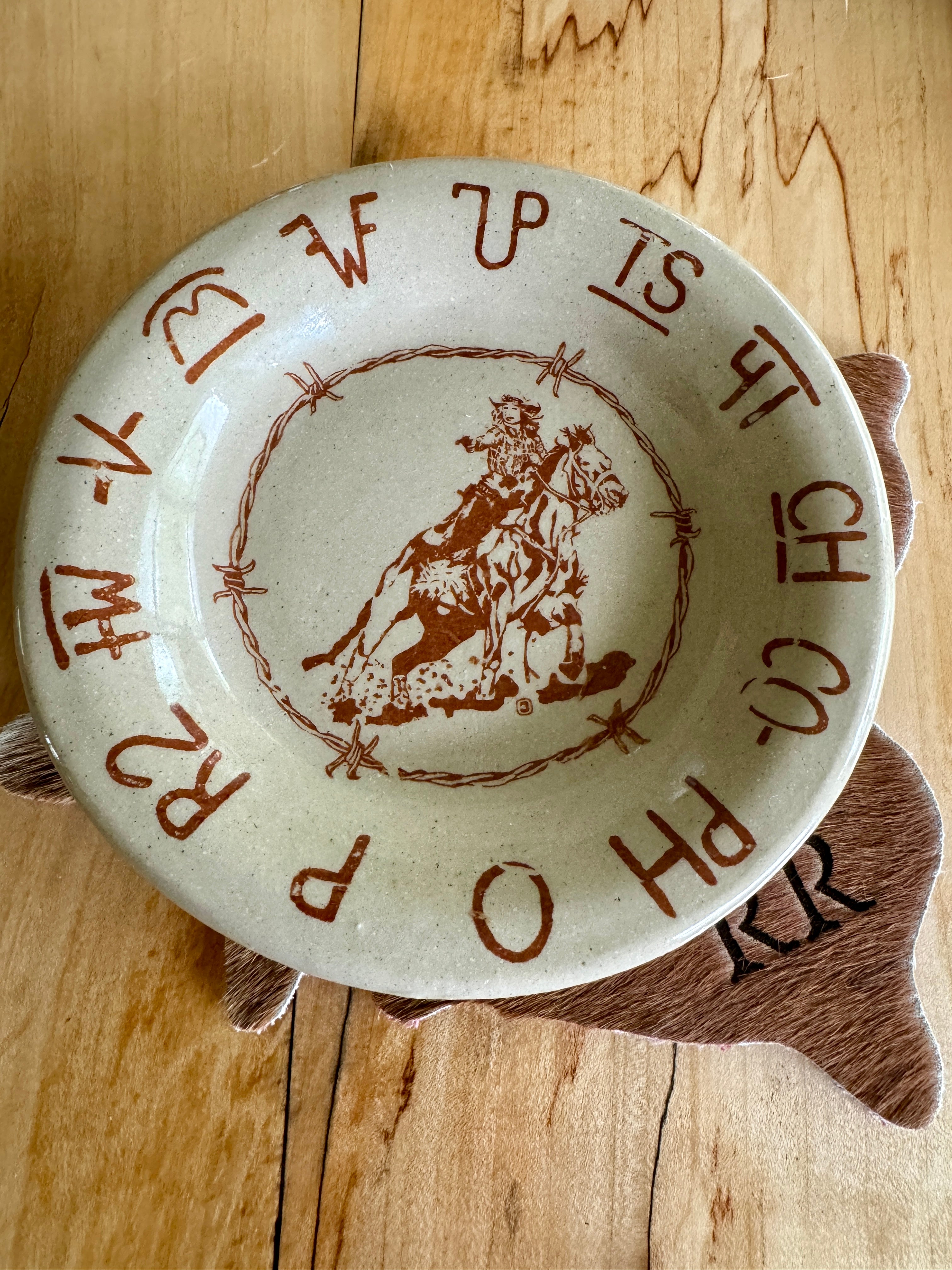 Blue Mountain Brands USA Western Saucer Plate with shooter on horse, brands and barbed wire made in Pendleton, Oregon USA