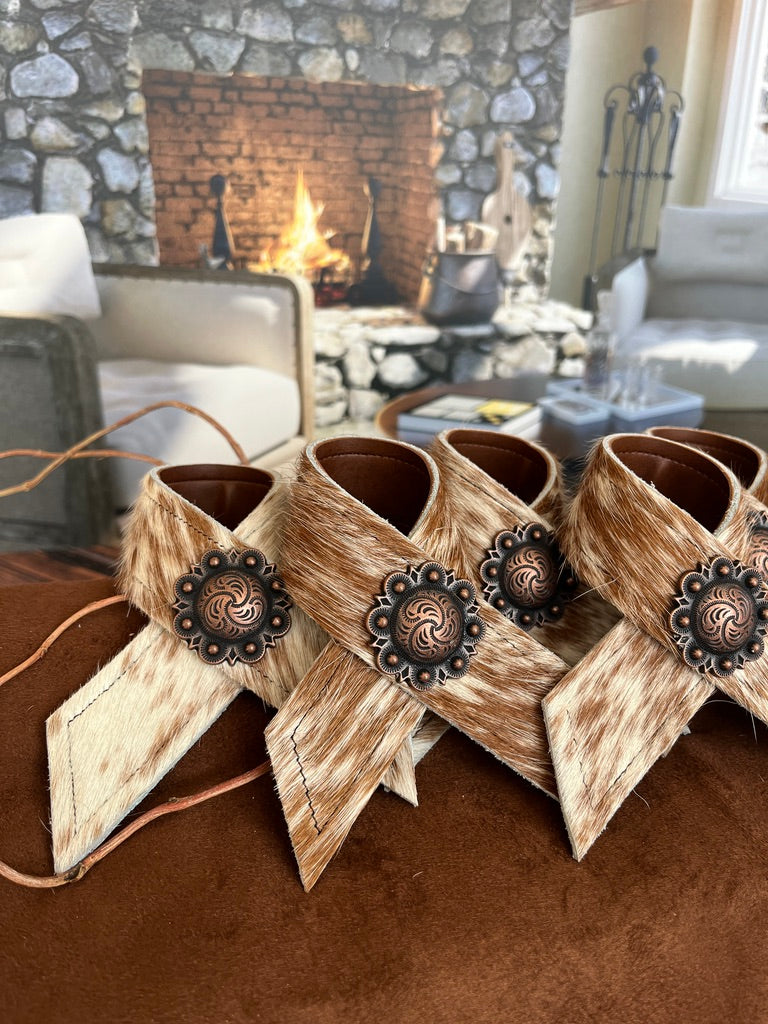 Hand made brown and white peppered cowhide napkin rings with berry conchos - Your Western Decor