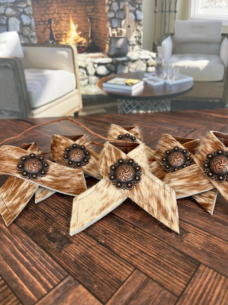 Hand made brown and white peppered cowhide napkin rings with berry conchos - Your Western Decor