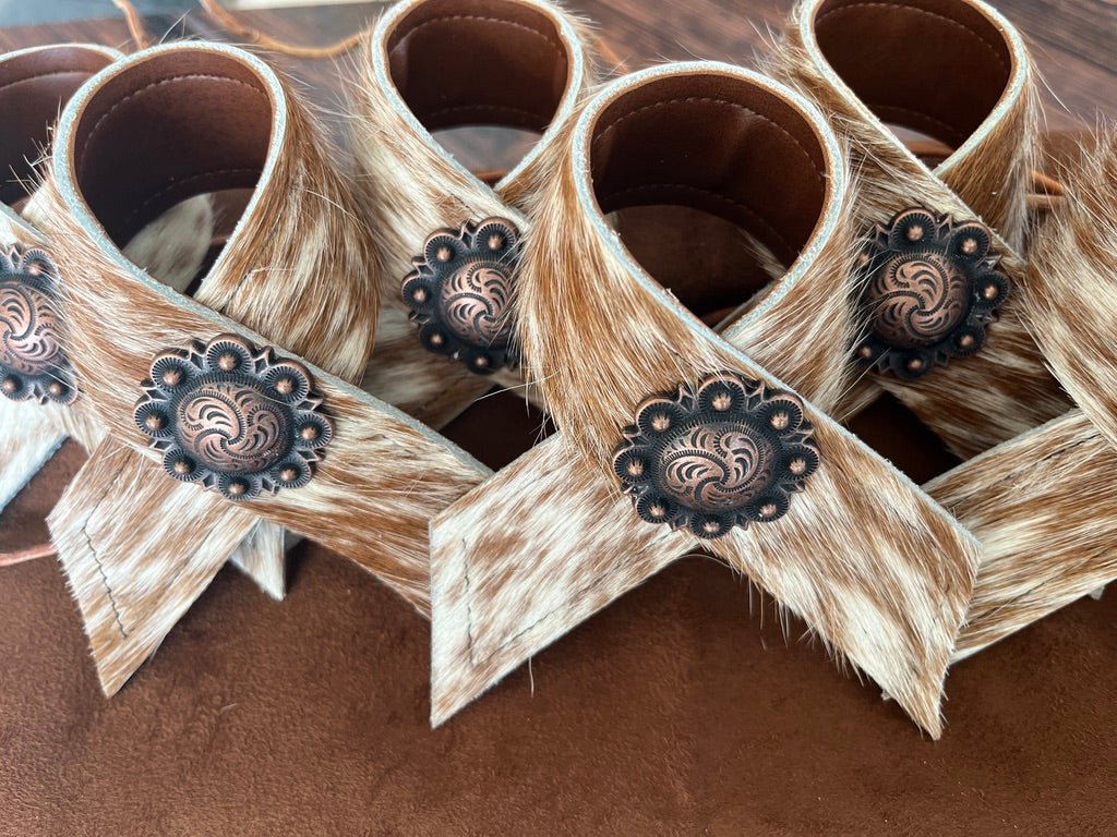 Hand made brown and white peppered cowhide napkin rings with berry conchos - Your Western Decor