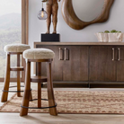 Wooden bar stools with cushioned seats in a room with a wooden cabinet and decorative items - Blue Mountain Brands USA