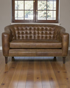 Brown leather sofa in a room with wooden flooring and a window - Blue Mountain Brands USA Home Furnishings 