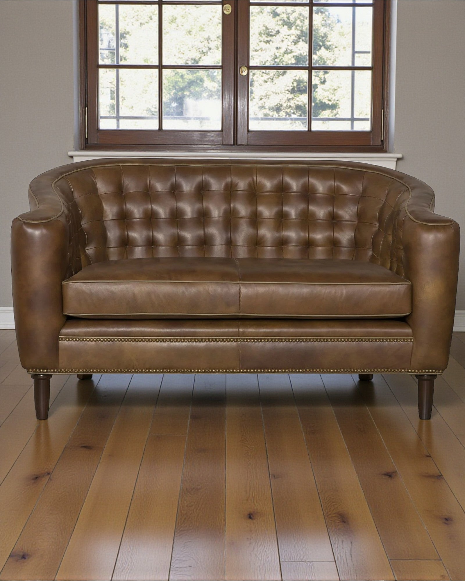 Brown leather sofa in a room with wooden flooring and a window - Blue Mountain Brands USA Home Furnishings 