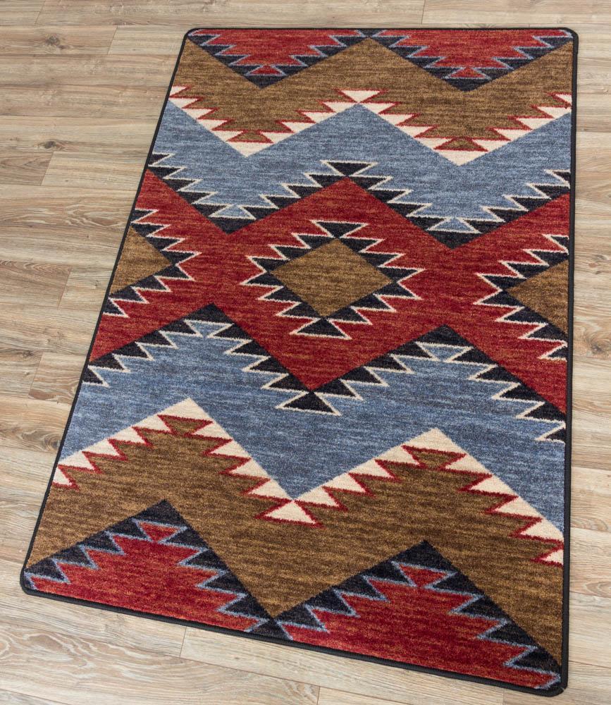 southwestern area rug with red, blue, and brown geometric diamond pattern on wood floor, western style performance rug