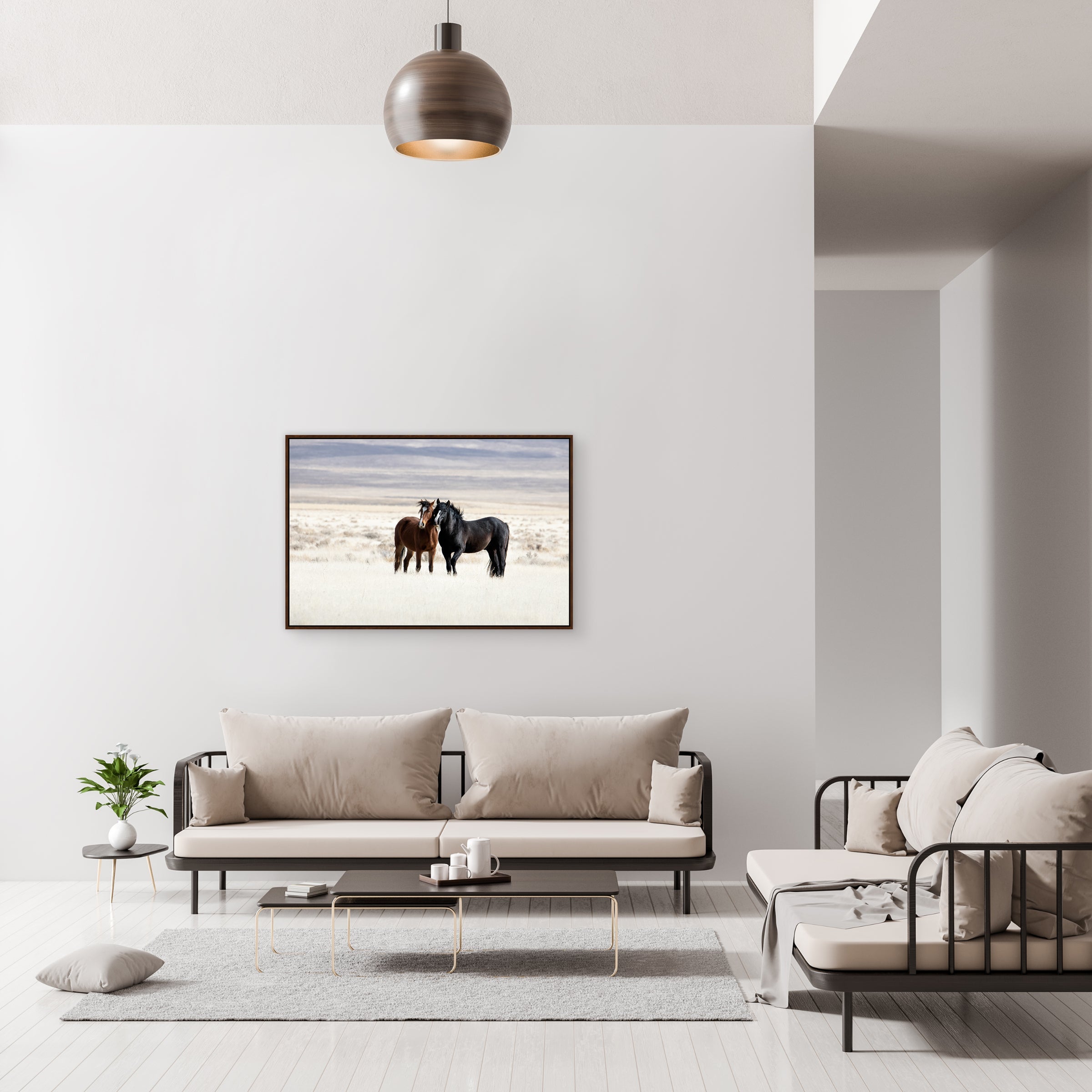 Modern living room with a sofa, chair, and framed picture of two horses on the wall - Blue Mountain Brands USA
