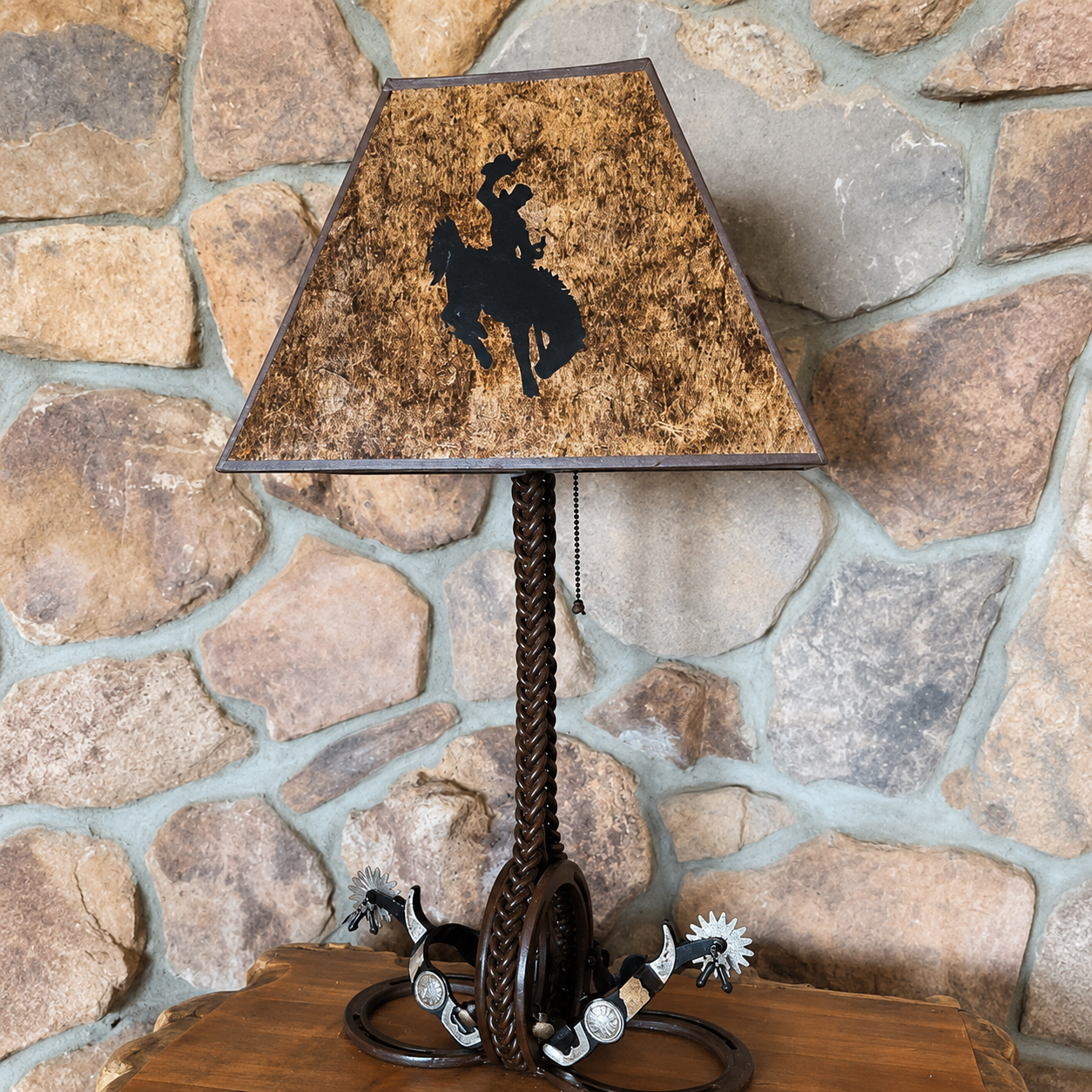 Custom made iron spur western table lamp with spurs, horseshoes, and mica lamp shade with bronc