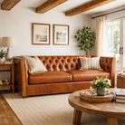 Cozy living room with a brown leather sofa, wooden coffee table, and decorative elements - Blue Mountain Brands USA
