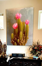 Decorative painting of a cactus with pink flowers on a wall above a table - Art by Sherri Alexander for Blue Mountain Brands USA