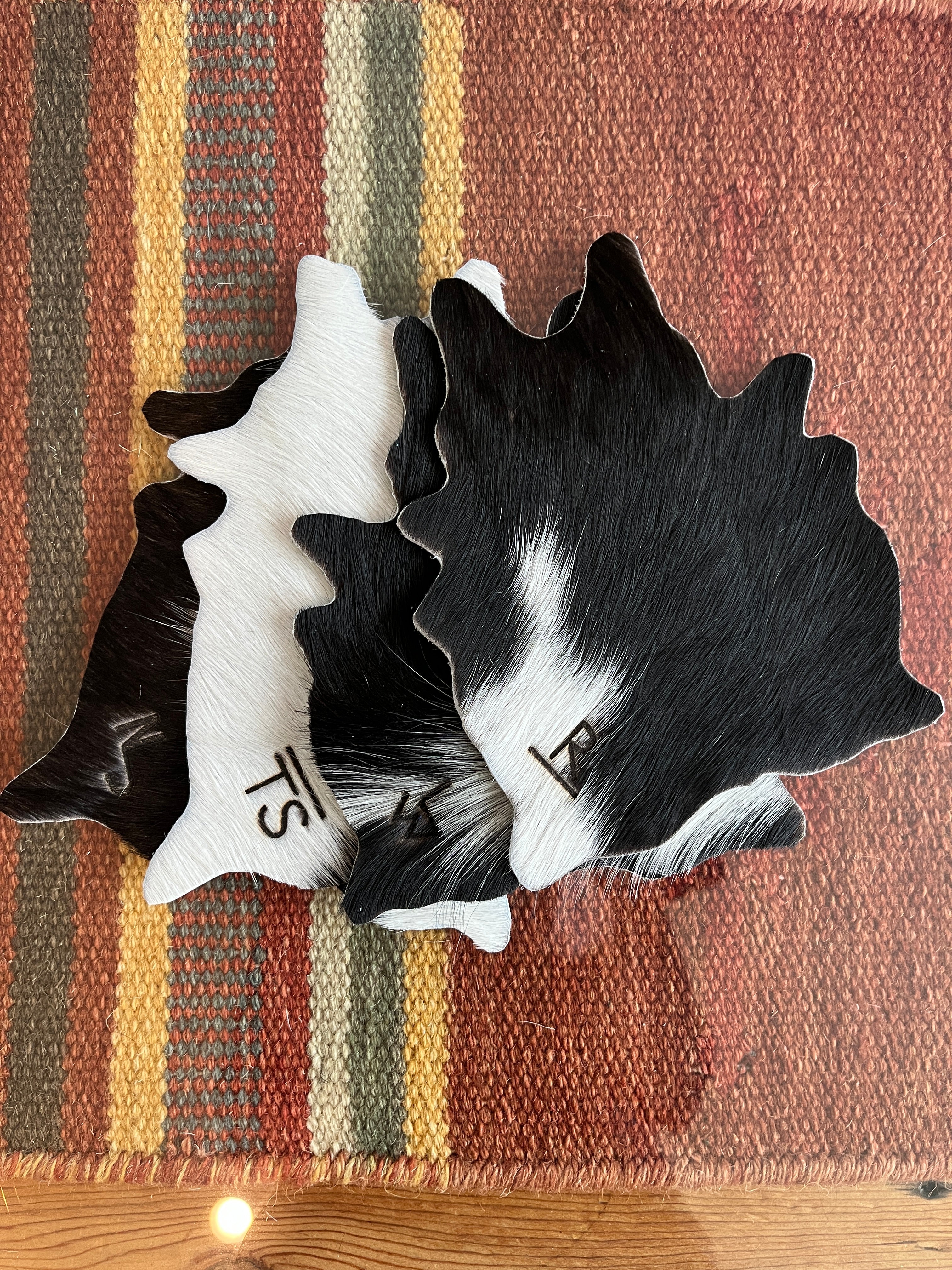 Custom branded black and white cowhide coasters by Your Western Decor