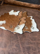 Custom branded brown white cowhide coaster set - Your Western Decor