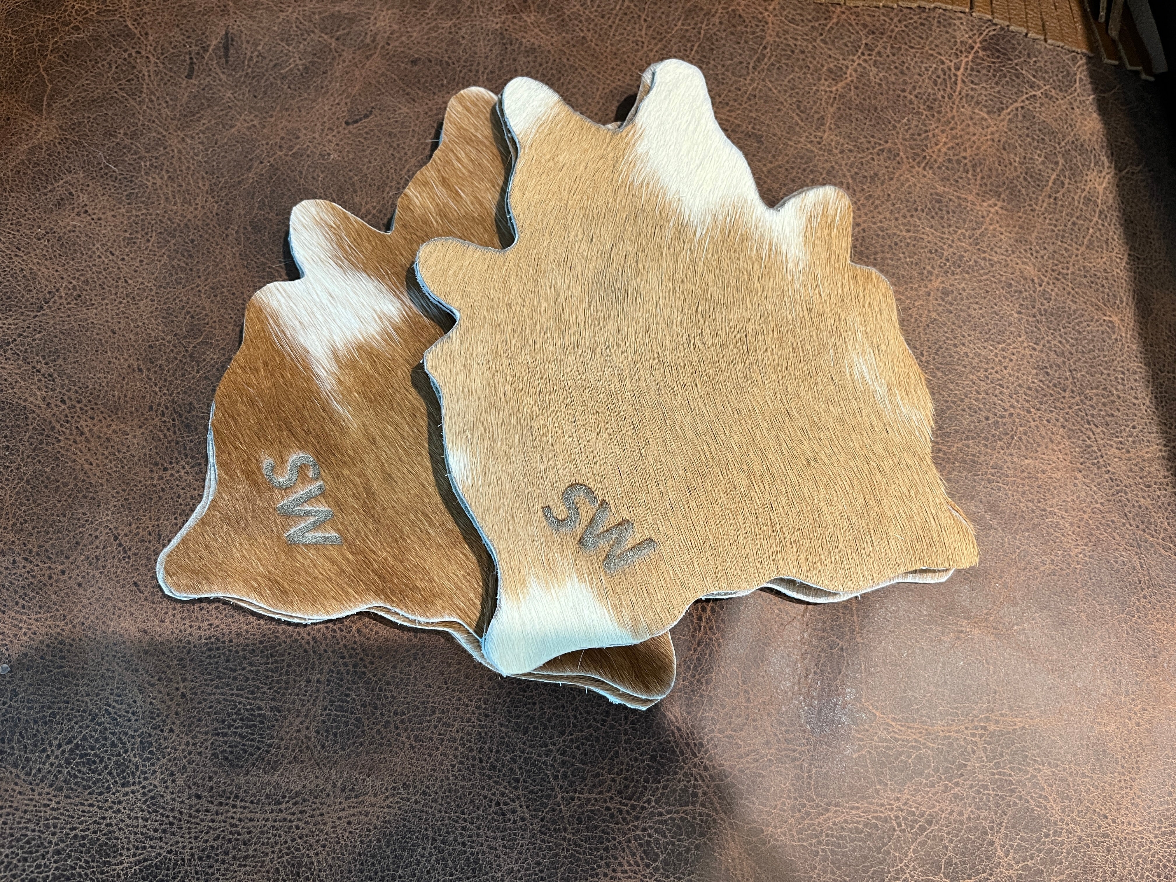 Brown and white branded cowhide coasters - Your Western Decor