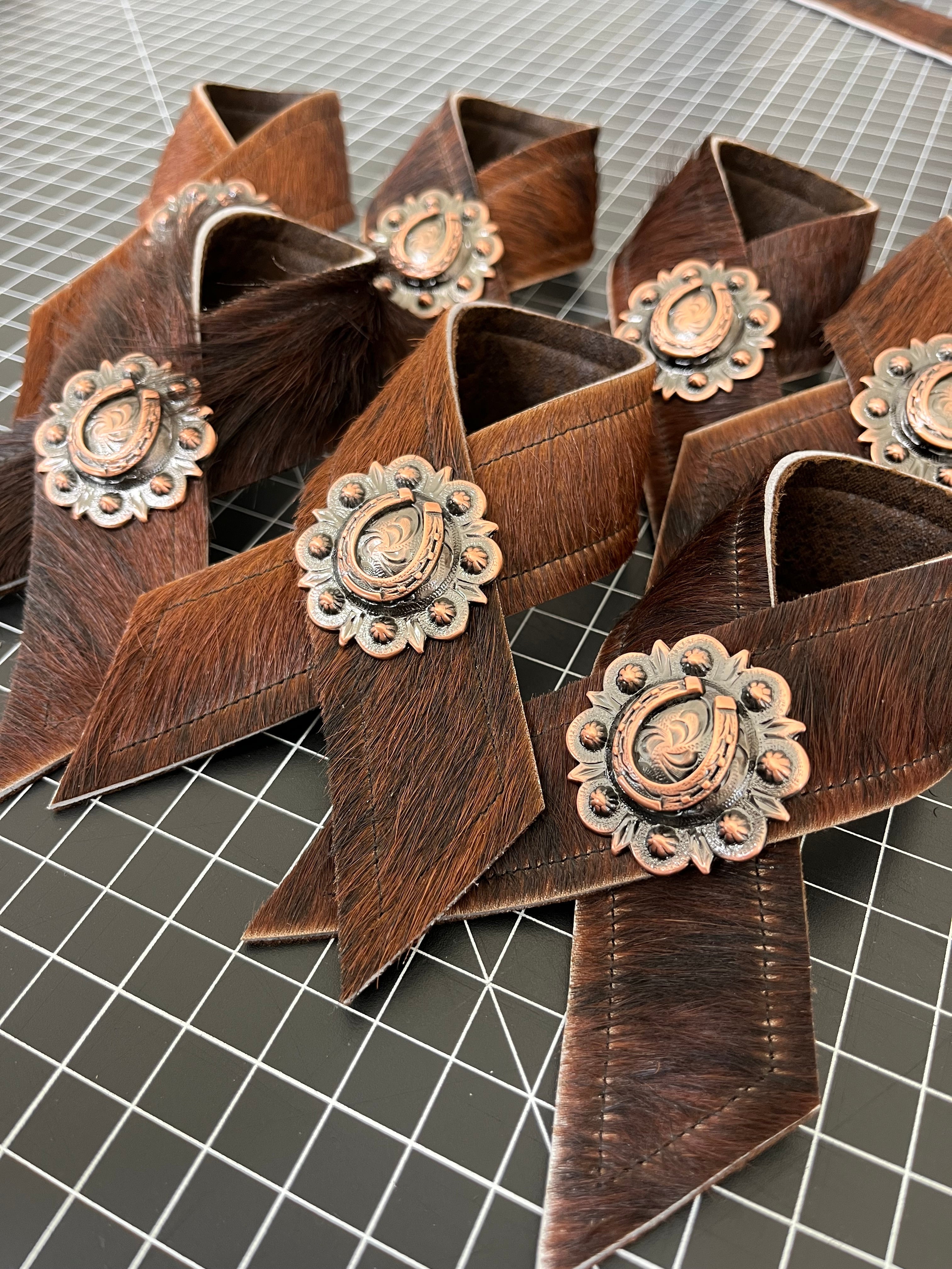 Brindle cowhide and horseshoe concho napkin rings handmade in the USA by Blue Mountain Brands USA Home Decor