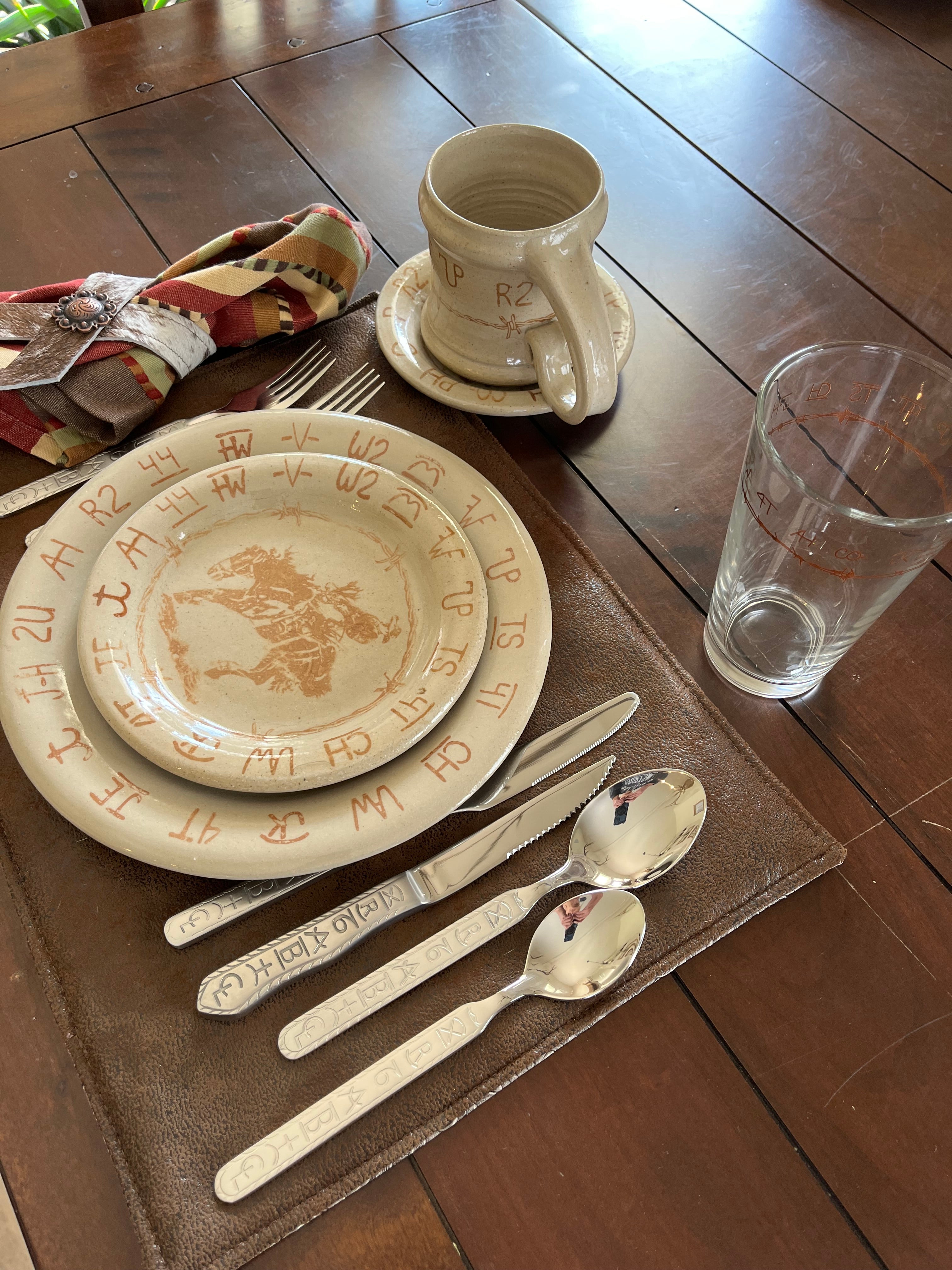 bronc and brands bread plate, salad plate, cup, saucer, napkin ring, pint glass and flatware 